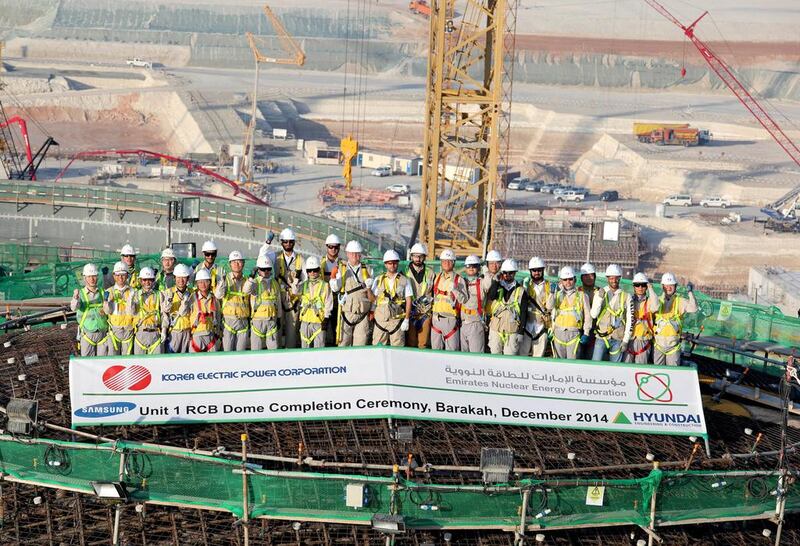 Workers celebrate the completion of the concrete dome for the Unit 1 Reactor Containment Building in Barakah. WAM