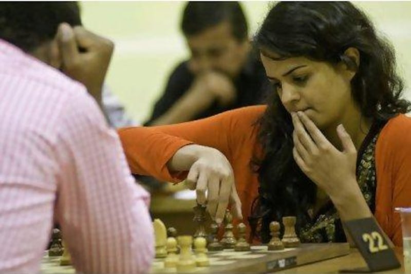 Tania Sachdev, an International Master chess player from India, makes a move against her opponent yesterday at the 13th Dubai Open Chess Championship, where $45,000 in prize money was handed out. Charles Crowell for The National