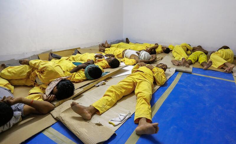 Ginco Contracting labourers rest in an air-conditioned room provided by the company. Under UAE law, employers are required to provide workers with a mandatory 2½-hour daily break to reduce health risks during the hottest summer months. Victor Besa for The National