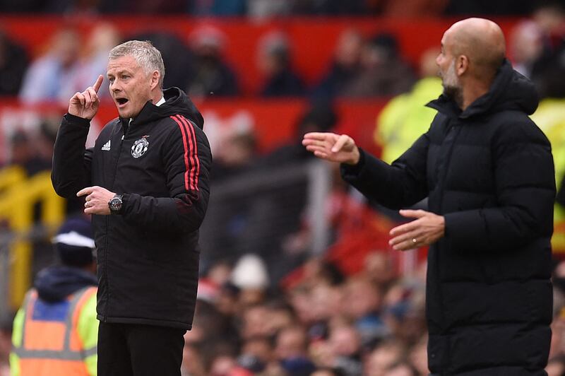Manchester United manager Ole Gunnar Solskjaer and Manchester City manager Pep Guardiola issue instructions from the touchline. AFP