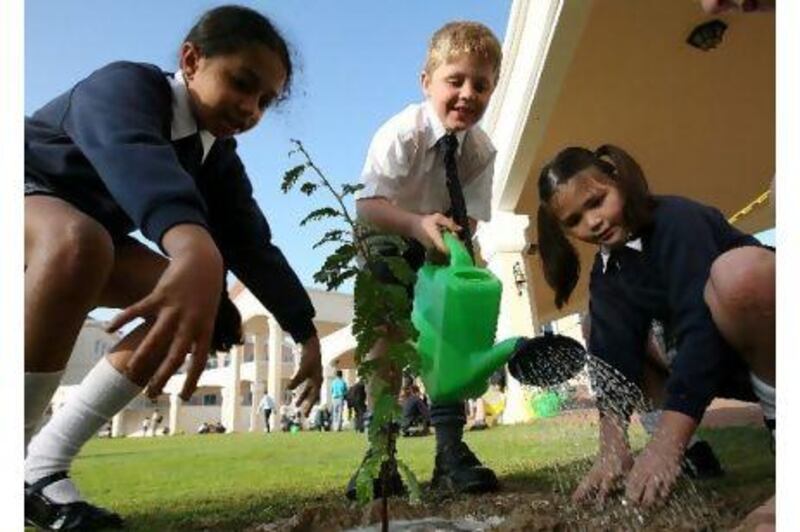 Students of Repton School planting trees in the campus at Nad Al Sheba 3 in Dubai.