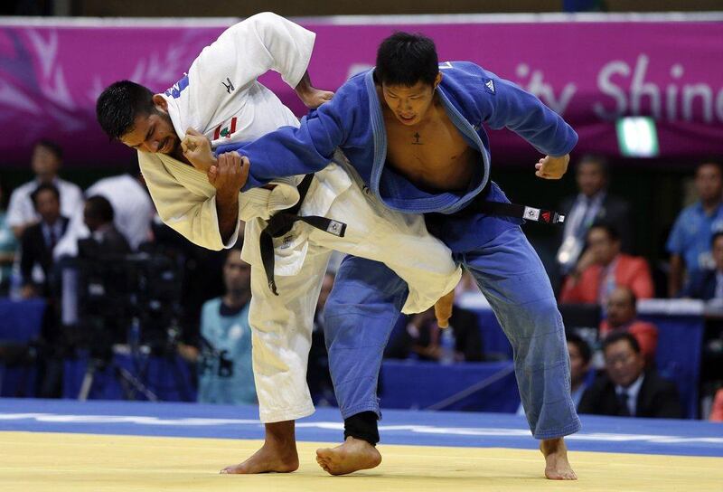 Lebanon's Nacif Elias, left, competes with South Korea's Kim Jae-bum, right, during the men's 81-kilogram judo gold medal match at the Asian Games on Sunday. Kim won the gold. Issei Kato / Reuters