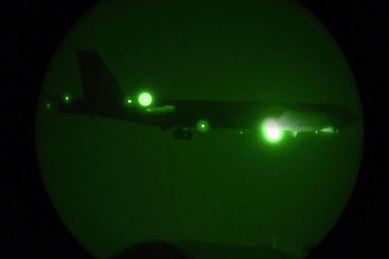 In this Thursday, May 9, 2019 photo released by the U.S. Air Force, a B-52H Stratofortress assigned to the 20th Expeditionary Bomb Squadron is seen through night vision coming in for a landing at Al Udeid Air Base, Qatar. The B-52 bombers ordered by the White House to deploy to the Persian Gulf to counter unspecified threats from Iran are beginning to arrive at a major American air base in Qatar. (Staff Sgt. Ashley Gardner/U.S. Air Force via AP)