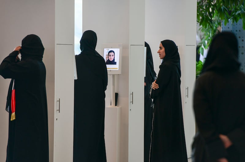 Face recognition technology set up before voters enter the voting area in Abu Dhabi. Khushnum Bhandari / The National 
