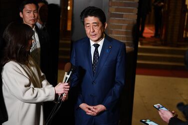 Japan's Prime Minister Shinzo Abe speaks to the press in front of the prime minister's residence in Tokyo on March 24, 2020.  Japan is planning to announce a stimulus package to combat the coronavirus pandemic. / AFP / POOL / CHARLY TRIBALLEAU