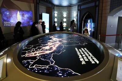 Visitors looking at the map of Silk Road at the Uzbekistan pavilion. Pawan Singh/The National