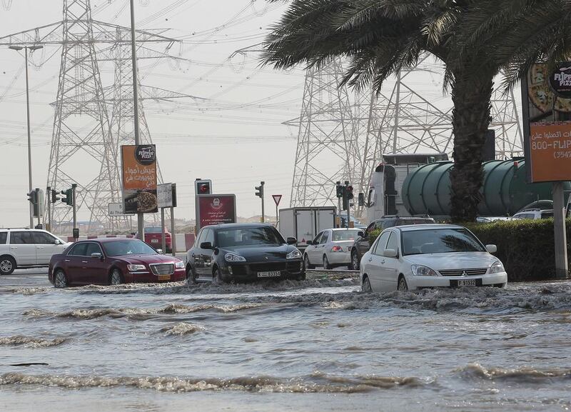 Motorists heading towards Ibn Battuta Mall negotiating waterlogged streets.  Jeffrey E Biteng / The National