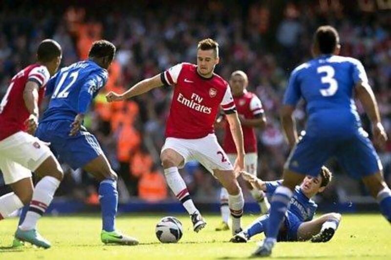 Arsenal's Carl Jenkinson, centre, employs his passing skills during a match against Chelsea in the English Premier League last month. Adrian Dennis / AFP