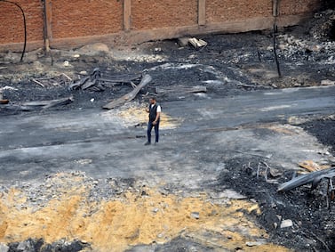 A worker at the scene of a fire that destroyed Al Ahram Studio in Cairo. Reuters