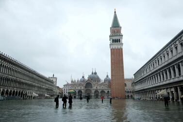 People wade through a flooded St. Mark's Square during a period of seasonal high water in Venice, Italy, last month. Reuters