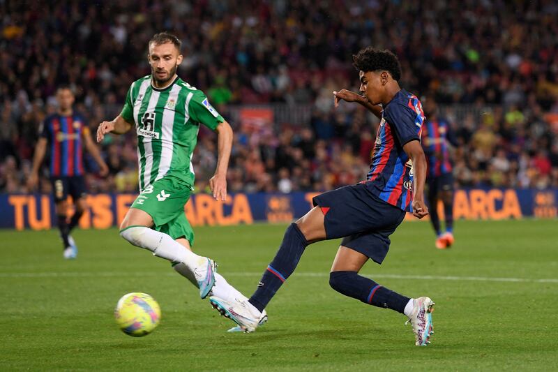 Lamine Yamal plays a pass under pressure from Real Betis defender German Pezzela. AFP