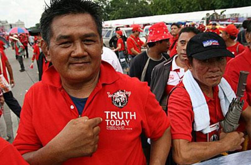 A red-shirted pro-Thaksin protester demonstrates for justice and calls for prime minister Abhisit Vejjajva to step down.