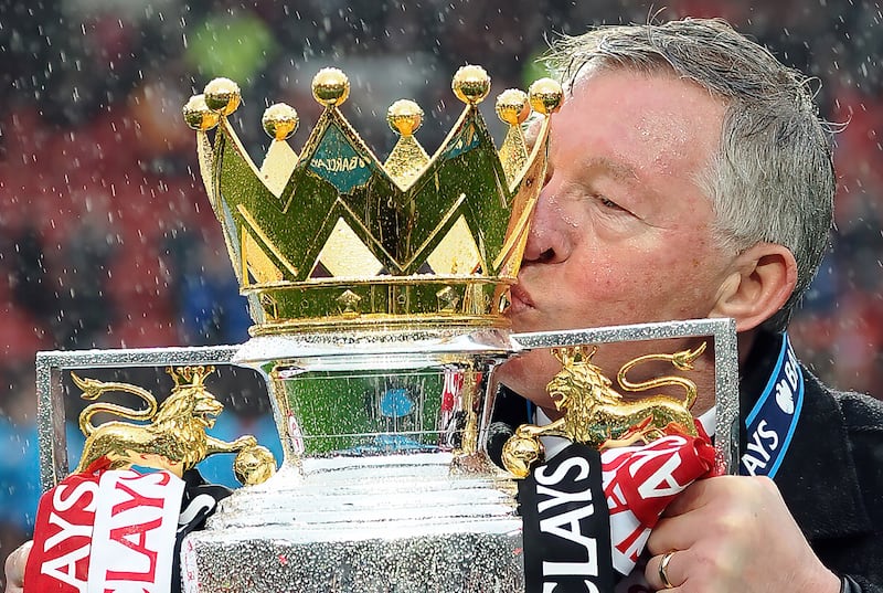 Sir Alex Ferguson kisses the Premier League Trophy after winning the title. 12/05/2013. Andrew Yates / FPA / LDY Agency