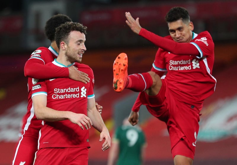 Diogo Jota, left, celebrates scoring their second goal in Liverpool's 2-1 win against Sheffield United on Sunday, October 24, with Roberto Firmino, right. Reuters