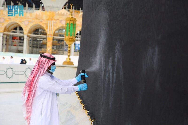 An official from the General Presidency for the Affairs of the Two Holy Mosques applies perfume to Kiswah, the cloth that covers the Kaaba, at the Grand Mosque in Makkah, Saudi Arabia. Reuters