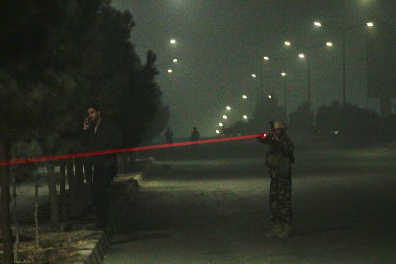 Afghan security officials take up positions near the scene of an attack by armed men at an upscale hotel in Kabul, Afghanistan. Jawad Jalali / EPA