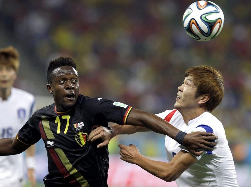 Divock Origi of Belgium vies for the ball with Kim Young-gwon of South Korea during their match on Thursday at the 2014 World Cup in Sao Paulo, Brazil. Thanassis Stavrakis / AP