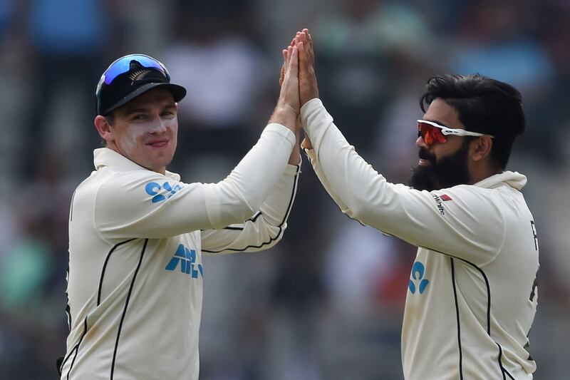 New Zealand's Ajaz Patel celebrates with Tom Latham after taking the wicket of India batsman Jayant Yadav for a duck. AFP