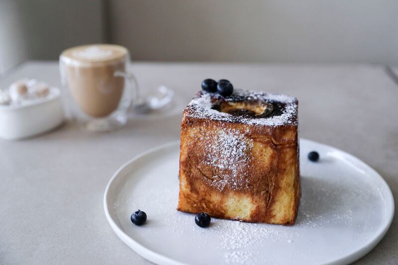 Creme brulee French toast dessert and latte, popular on the menu of No Fifty Seven Boutique Cafe. Khushnum Bhandari / The National