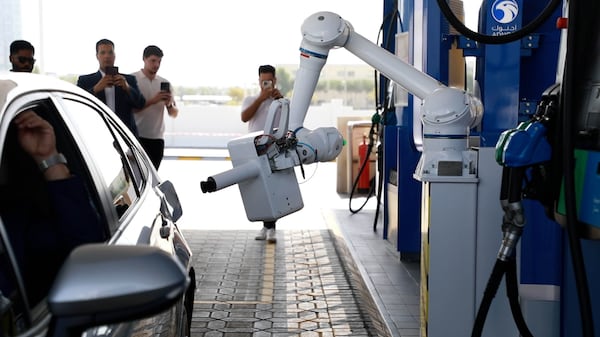 A robotic fuelling arm at an Adnoc petrol station in Al Reem Island, Abu Dhabi. Wajod Alkhamis / The National