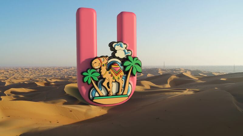 'U' looms over the desert, and a stylised scene of a camel at an oasis.