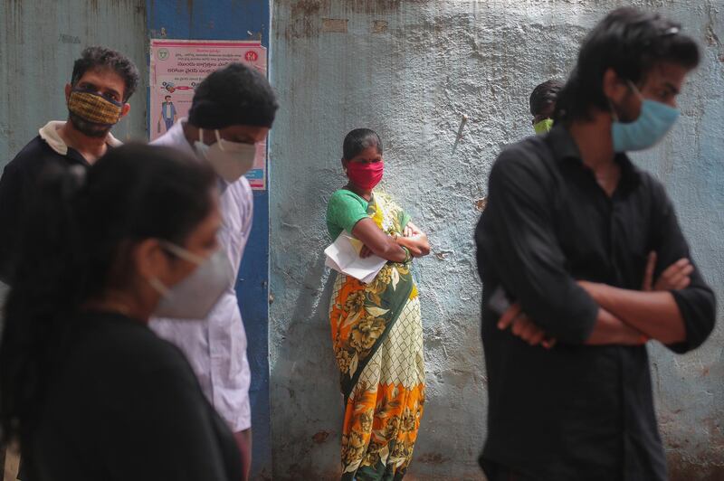 People wait to give their nasal swab samples to test for Covid-19 in Hyderabad, India. AP Photo