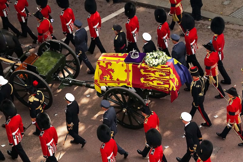 The coffin of Queen Elizabeth II, adorned with the Royal Standard and the Imperial State Crown is pulled by a gun carriage of The King's Troop Royal Horse Artillery during a procession from Buckingham Palace to the Palace of Westminster, London, on September 14, 2022. AFP