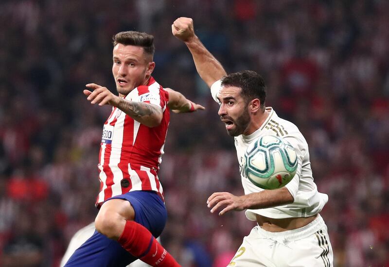 Real Madrid's Dani Carvajal in action with Atletico Madrid's Saul Niguez. Reuters