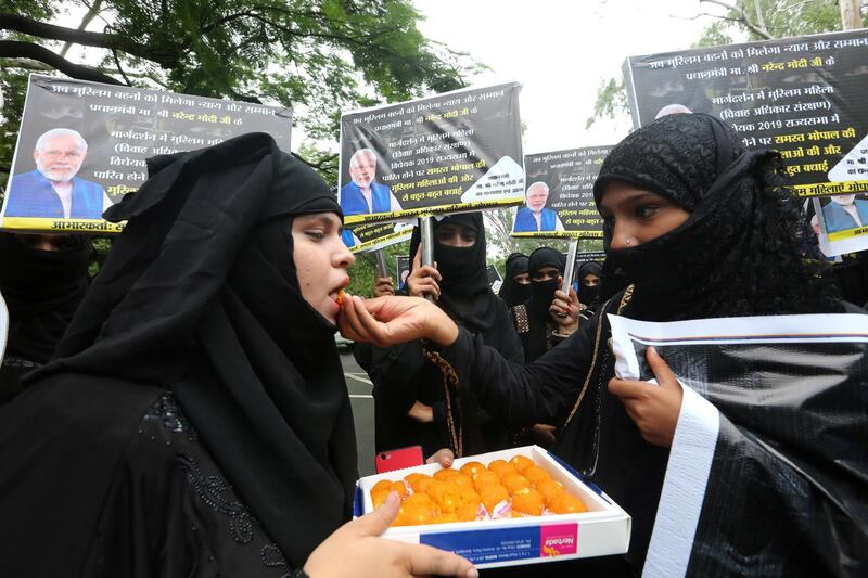 epa07749970 Indian Muslim women offer sweets to each other as they celebrate passing a law outlawing instant divorce practice for Muslims, in Bhopal, India, 31 July 2019. Rajya Sabha, the Upper house of India's Parliament on 30 July passed a bill outlawing the practice of instant triple talaq 'Divorce in Islam', with up to three years of jail term for the husband, five days after the law was approved by Lok Sabha (lower house of Parliament). The Muslim practice of triple talaq follows the rule where a husband can end a marriage unilaterally and instantly by repeating the word 'talaq', meaning 'I divorce', three times.  EPA/SANJEEV GUPTA