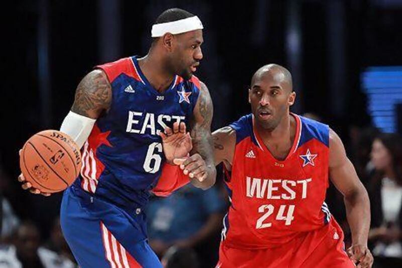 LeBron James, left, fends off a little fourth-quarter defense from Kobe Bryant during the NBA All-Star Game on Sunday. Ronald Martinez / Getty Images