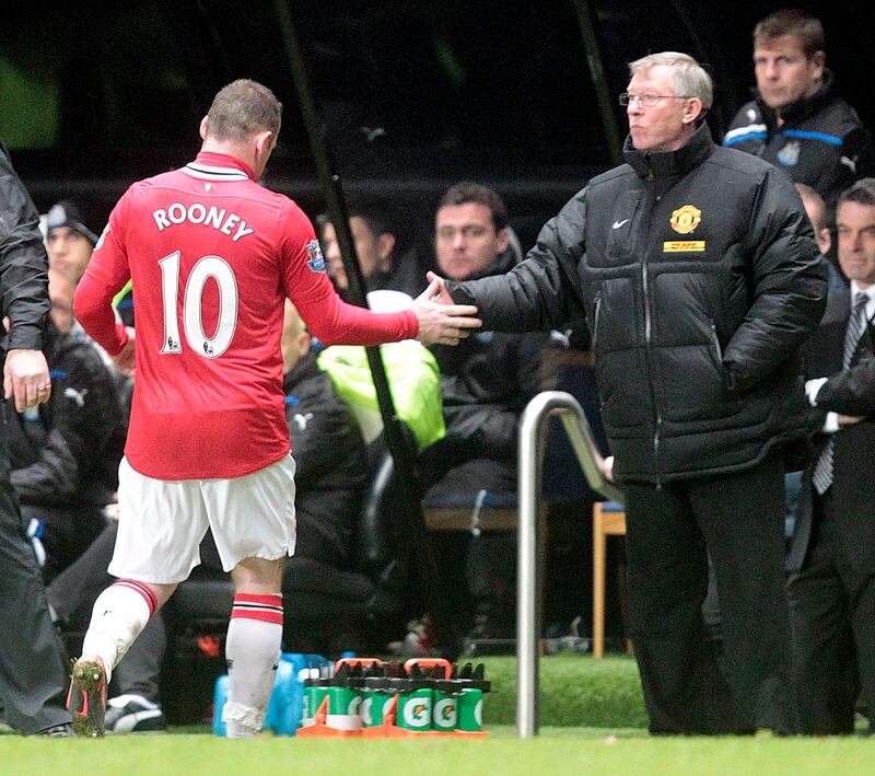 Manchester United manager Alex Ferguson substitutes Wayne Rooney against Newcastle United during a Premier League match at St James' Park on January 4, 2012. AFP
