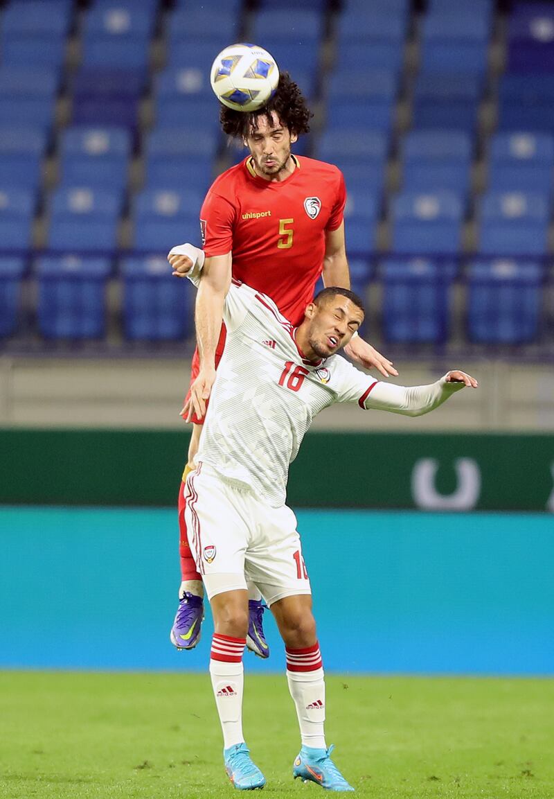 Syria's Amr Almidani of Syria beats Ali Saleh of the UAE to a header. Chris Whiteoak / The National