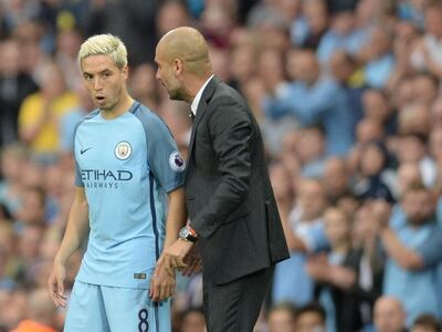 Pep Guardiola, right, would bear witness to Samir Nasri's difficult nature. Oli Scarff / AFP