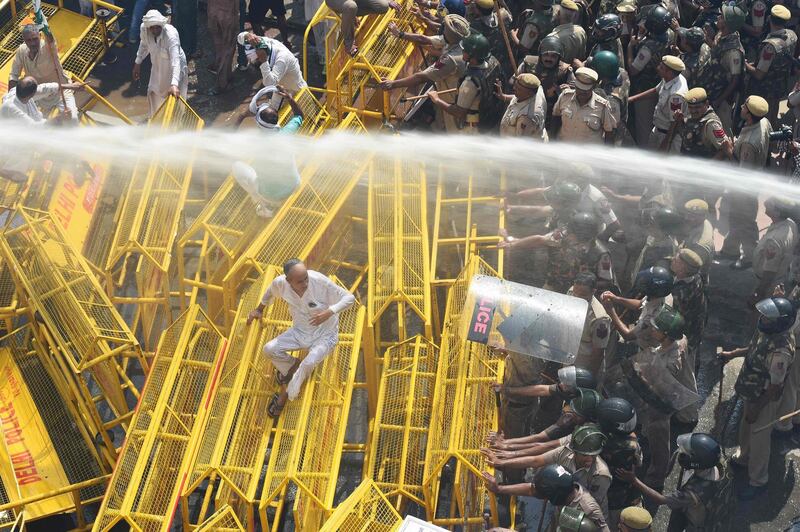 Police use water cannon to disperse and stop farmer activists of the Bhartiya Kisan Union at the border with Ghazipur during their march to New Delhi. Prakash Singh/AFP