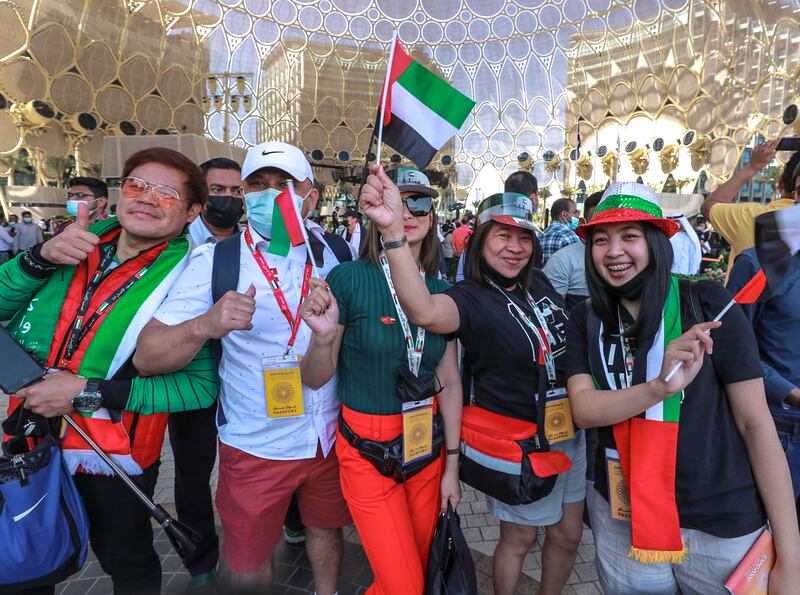 People dressed to celebrate the UAE's special day arrive at Expo 2020 Dubai. Victor Besa / The National