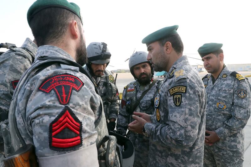 Iranian troops discuss tactics during the naval exercise.