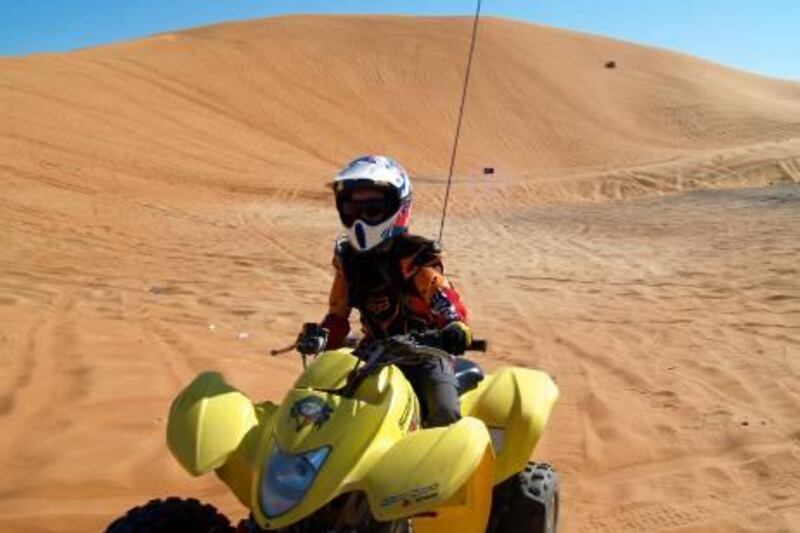 The dune known as Devil's Plunge is a popular playground - Dar Rossetti, 12, at the handlebars, prefers to avoid the evening hours - Paolo Rossetti for The National