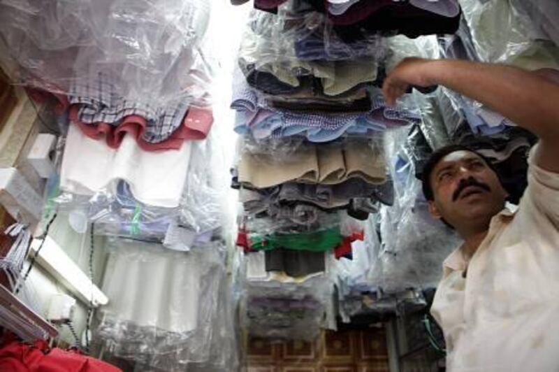 March 22, 2012 (Abu Dhabi) Mohammed Ali works at the Eissa Al Khameeri Dress and Ironing Shop in Abu Dhabi. New municipality rules may force the store to close because of the size of the store March 22, 2012.  (Sammy Dallal / The National)
 

MAR25bk