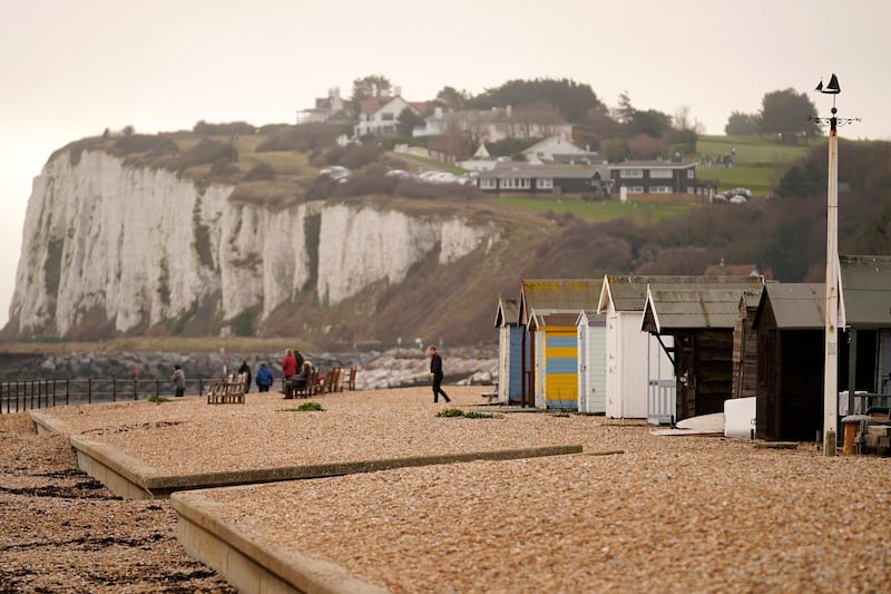 DOVER, ENGLAND - DECEMBER 30: People walk on the beach at Kingsdown, near Deal, where six migrants landed by dinghy early this morning on December 30, 2018 in Dover, England. The growing number of migrants attempting to cross the English Channel has been declared a "major incident" by UK home secretary Sajid Javid. (Photo by Christopher Furlong/Getty Images)