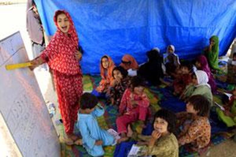 Displaced Pakistani children attend a class in a makeshift school established by Unicef at the Jala refugee camp in Mardan.