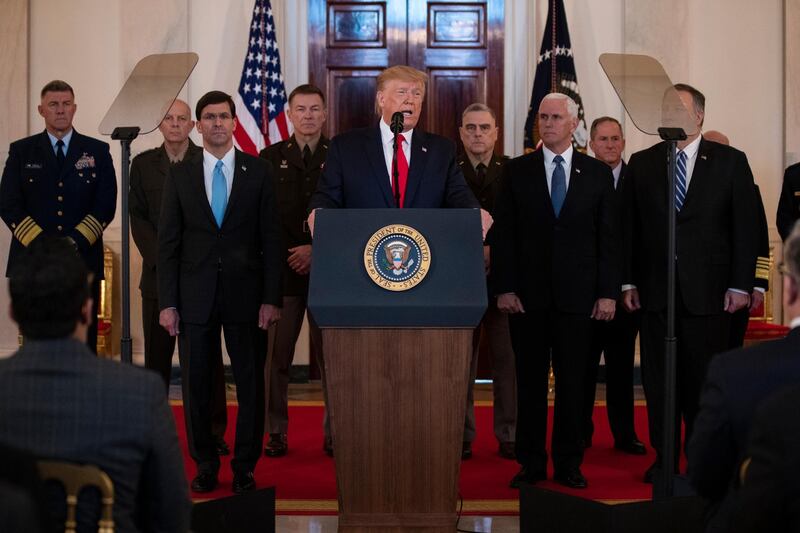 President Donald Trump addresses the nation from the White House on the ballistic missile strike that Iran launched against Iraqi air bases housing U.S. troops, Wednesday, Jan. 8, 2020, in Washington, as Secretary of Defense Mark Esper, Chairman of the Joint Chiefs of Staff Gen. Mark Milley, Vice President Mike Pence, and Secretary of State Mike Pompeo, and others look on. (AP Photo/ Evan Vucci)