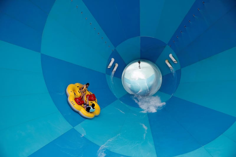 People enjoy a water slide in Yongin, South Korea. Reuters