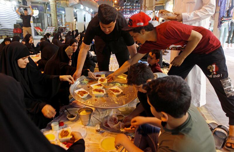 Women get ready to break their fast at a communal iftar in Najaf, Iraq. Reuters