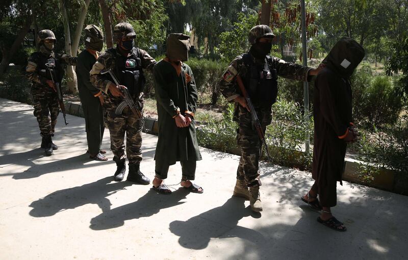 Afghan security officials escort a group of suspected militants who are accused of planning attacks on government and security forces after their arrest in Jalalabad. EPA