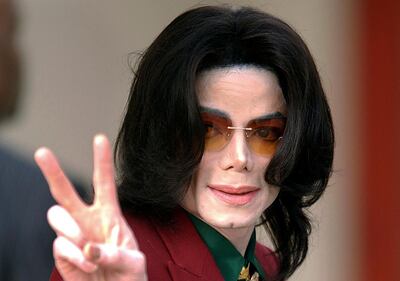 FILE - In this Thursday, March 17, 2005, file photo, pop star Michael Jackson acknowledges his fans as he arrives at the Santa Barbara County Courthouse, in Santa Maria, Calif. The Michael Jackson estate is donating $300,000 to help people in the entertainment industry hurt by the coronavirus pandemic. The donations will focus on Broadway workers, as well as workers in Las Vegas and in the music industry, Jackson's estate announced Wednesday, March 25, 2020. (AP Photo/Michael A. Mariant, File)