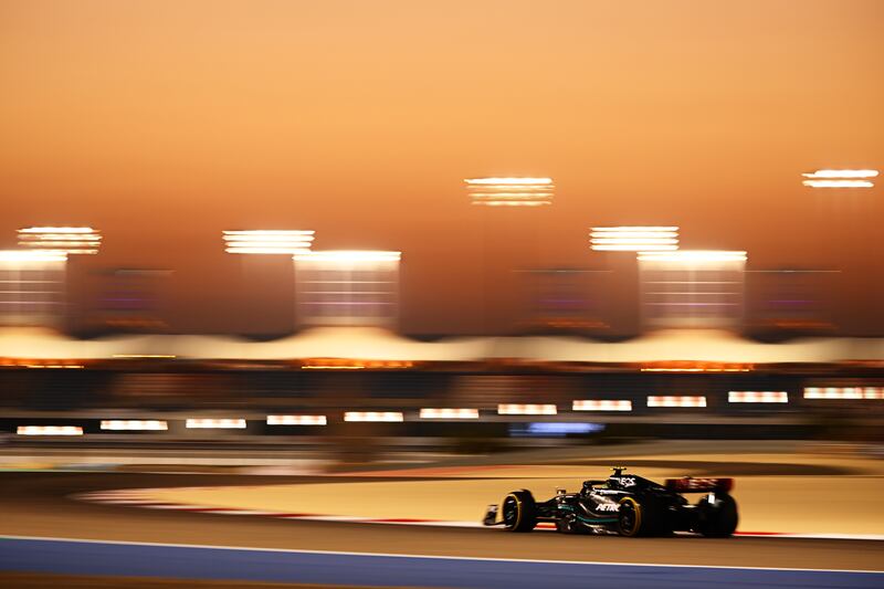 Lewis Hamilton of Great Britain drives his Mercedes under lights at Bahrain International Circuit. Getty