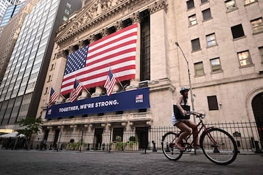 A woman rides past the New York Stock Exchange. For the first time in a while, many wealthy industrialised countries are doing better – and in some cases, much better –than the US amid Covid-19. AFP