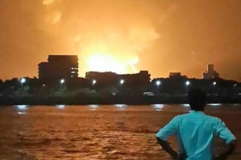 A man watches the INS Sindhurakshak burn in its naval dockyard in southern Mumbai.