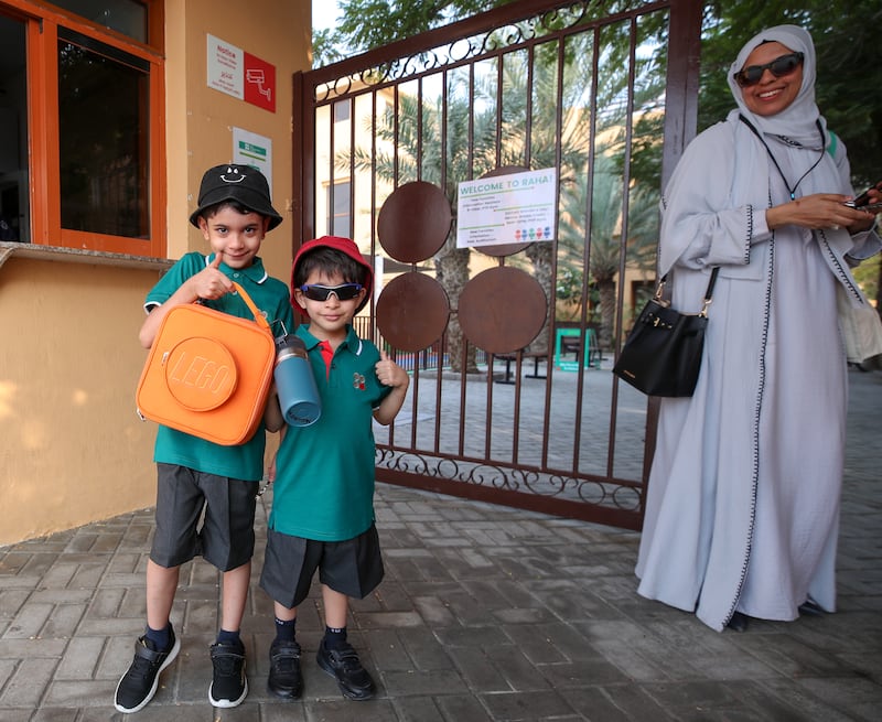 Hudhayfah and Harith Mannan arrive on the first day of school at Raha International School Abu Dhabi. Victor Besa / The National