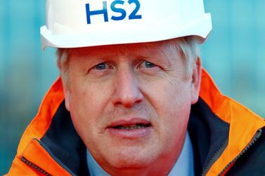 Britain's Prime Minister Boris Johnson looks on during a visit to a construction site for the new High Speed 2 (HS2) rail project in Birmingham, England on February 11. Mr Johnson's cabinet have green-lit the high-speed rail line, despite the huge cost prediction and opposition from environmentalists. Eddie Keogh / Pool via AP